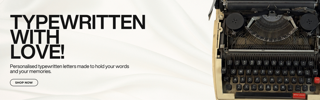 Vintage typewriter with text 'Typewritten with Love!' on a white backgroundslider_item_echeEE